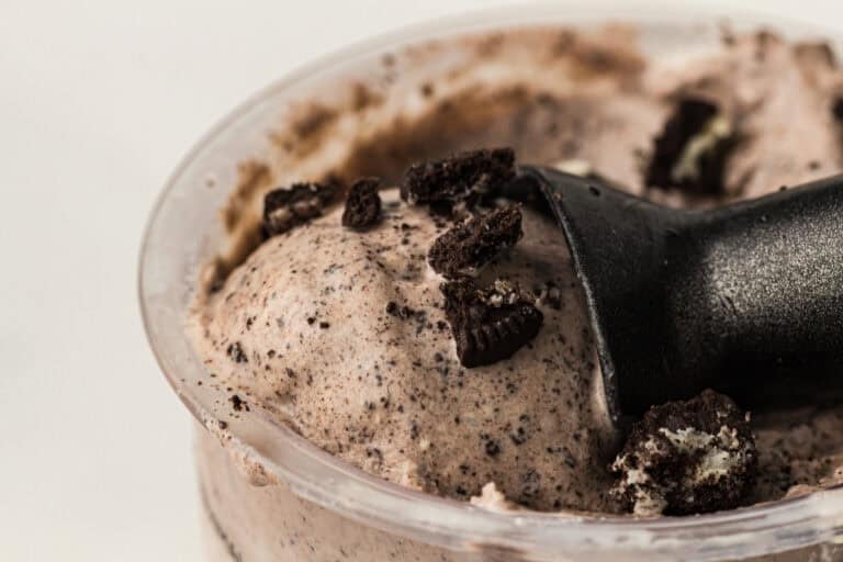 Using an ice cream scooper to scoop the ice cream.